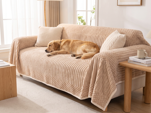 BubbleRib Plush Sofa Cover on a sofa in a bright living room with a relaxed dog